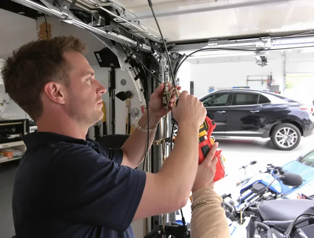 Vernon Garage Door Repair safety certified technician performing cable replacement in Vernon